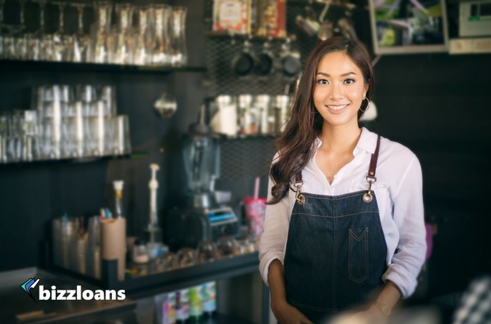 young and happy business owner in coffee shop