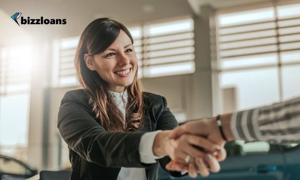 happy sales woman shaking hands with customer