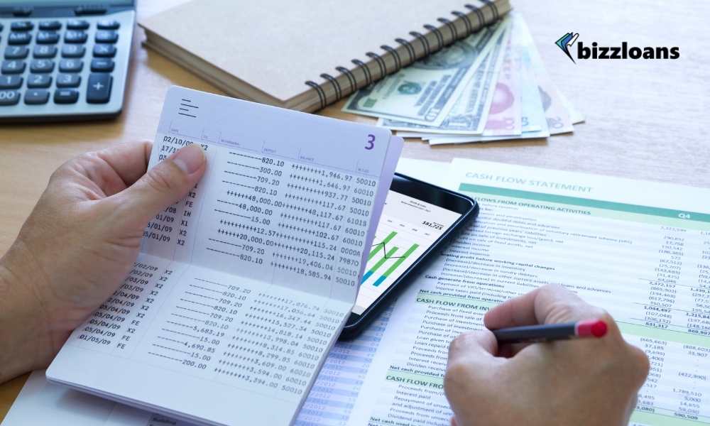 man writing down and checking bankbook