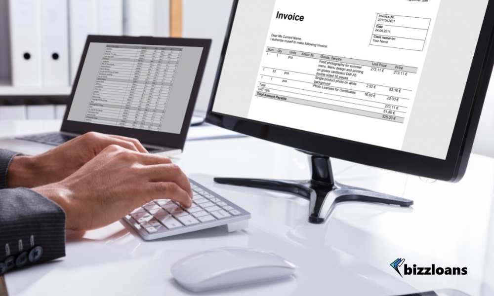  Businessperson Checking Invoice On Computer