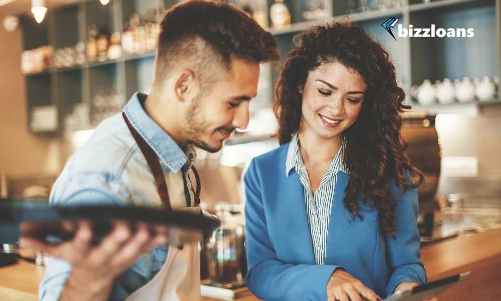 two business owners looking at a tablet in the cafe