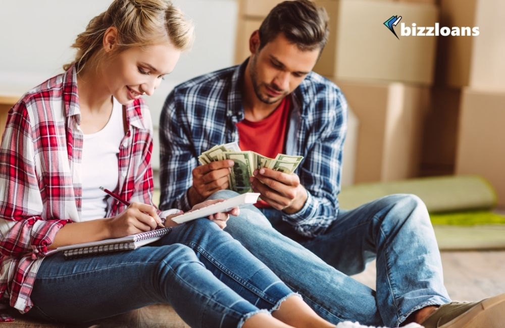 two business owners counting money to fund their business