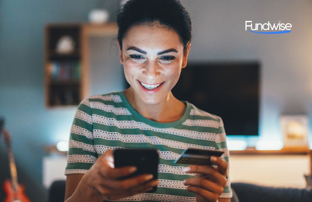 happy woman checking her finances on mobile phone