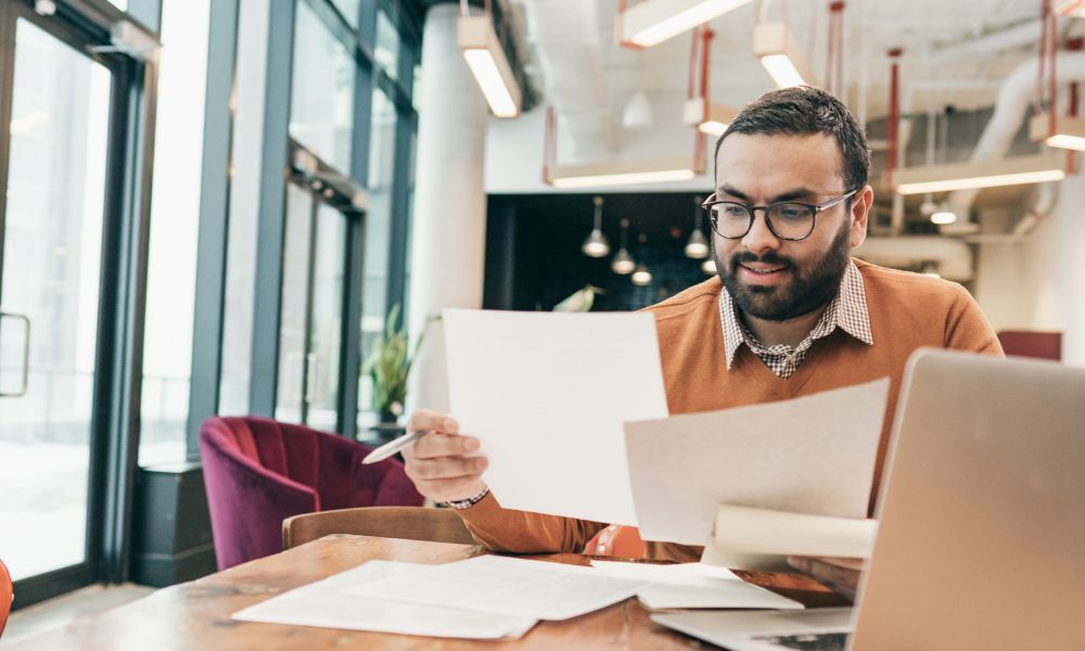 business man checking interest rates on paper