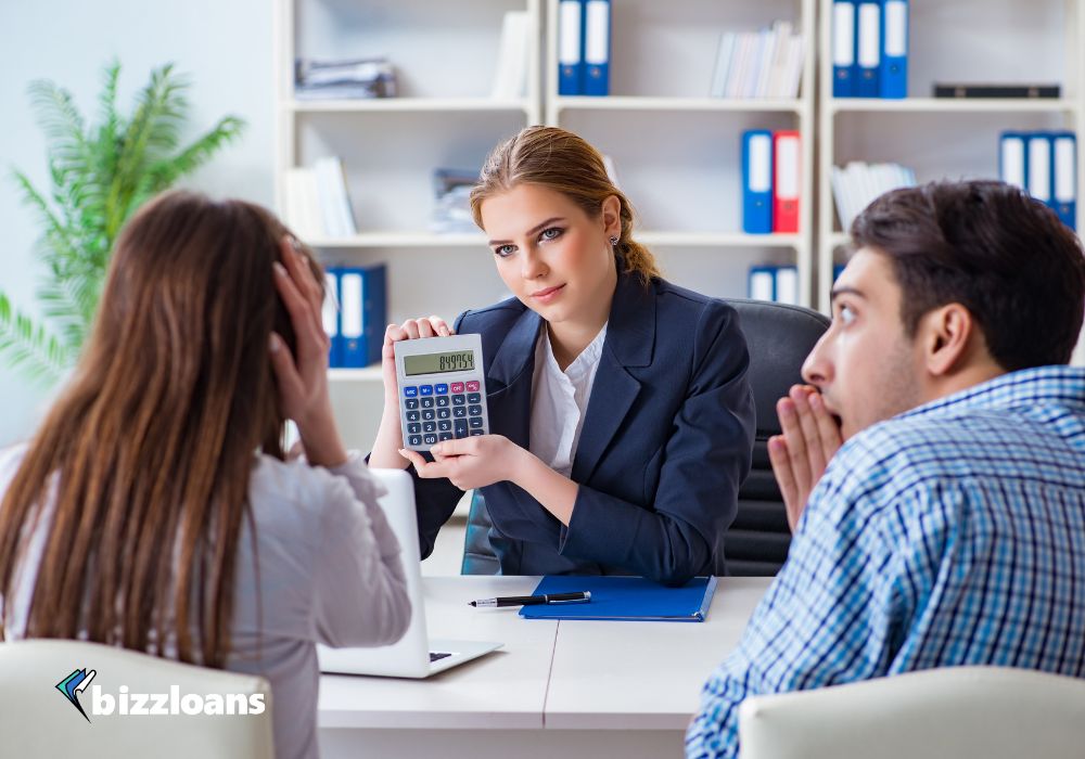 two business owners looking at high interest rates for loan