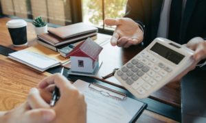 broker showing loan interest rate on calculator