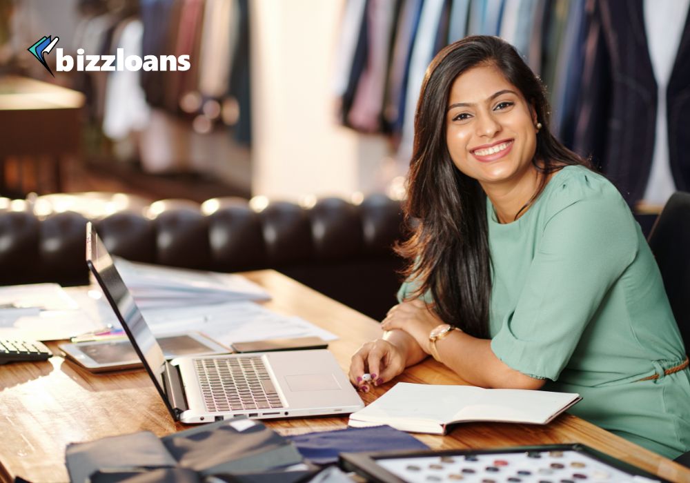 happy business owner on laptop searching for small business loans