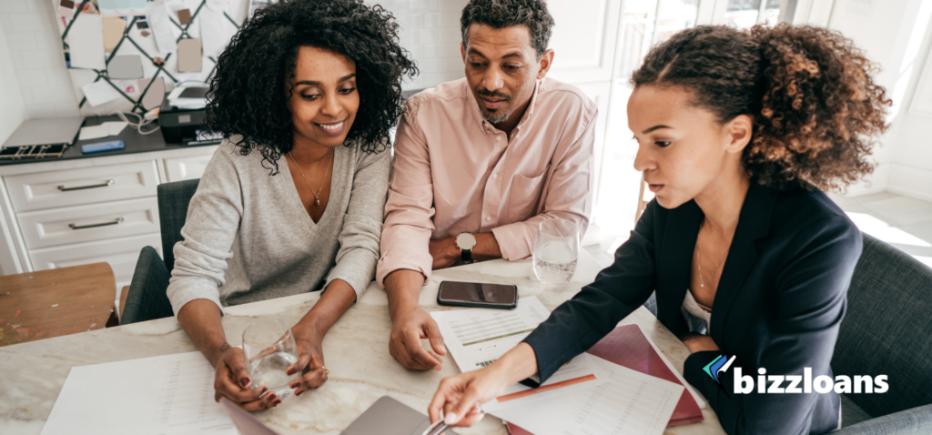 Women explaining to couple doing business with the apporval process and potential challenges